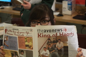 Senior Ericka Thomas holds up her 2004 issue of the Avonews--in only ten years, much has changed.