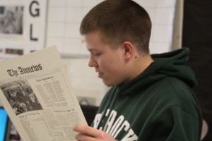 Senior Corey Clark studiously staring at his 1974 edition of The Avonews