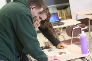 Seniors Corey Clark and Havilah Gaugler analyze their copy of old Avonews