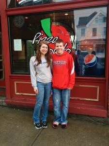 Amelia and Corey in front of Pizza Pronto