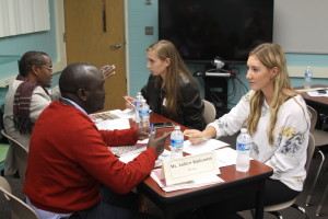 Mr. Kipkemboui and senior Sierra Hartings pictured in front, discussing Journalism and current events. Senior Abigail Oberdick, also pictured, researched the work of Mr. Yassin Wardere, a Somali journalist, before discussing the dangers of reporting in his home country. 