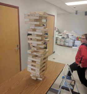 Students like _________________ kid on right took advantage of the Jenga tower station with Mr. Wolfe to build this tower. The Jenga activity was one of a number of new activities outside of the auditorium connected to the auction, including a flag football game, basketball game, cornhole, and Madden gaming. 